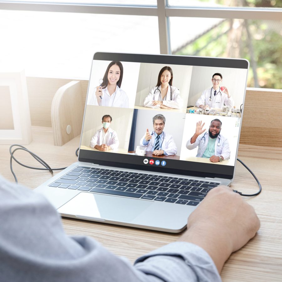 Close-ups on the computer screens a group of doctors greets the patients via online video calls. Concept of medical service. Consult a sick person online During the coronavirus spread